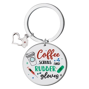 Detail of round stainless steel keychain with Coffee SCRUBS AND RUBBER gloves text