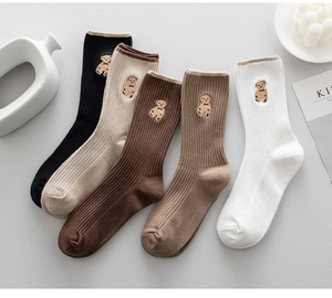 Detailed view of five pairs of cotton ribbed mid-tube socks with cute bear embroidery