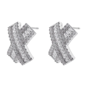 Detailed close-up of X-shaped silver earrings featuring rectangular and round zircon inlay