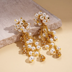 Elegant gold flower cluster earrings with white pearls and sparkling crystal tassels