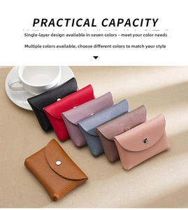 Flat lay of seven leather coin purses in various colors featuring lychee grain texture