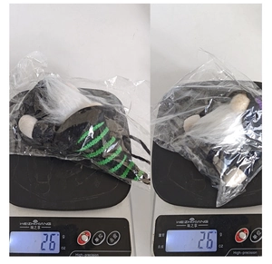 Close-up of a 26g Halloween faceless gnome doll being weighed on a digital scale