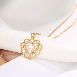Close-up of heart pendant necklace with micro-pave zircons and white cross detail