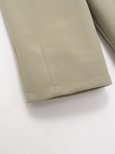 Detailed view of light sage green brushed fabric with precision double stitching