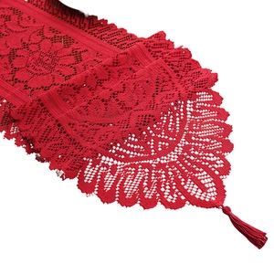 Red lace crochet table runner with tassels for Christmas and festive holiday dining decor