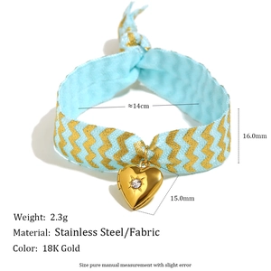 18K gold heart locket bracelet with light blue fabric strap and crystal accent