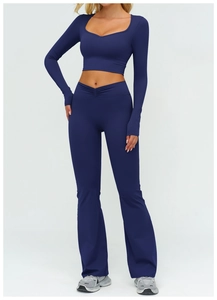 Detail of high-waisted flared yoga pants and long sleeve top in navy blue elastic fabric