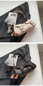 Detail view of vintage motorcycle bag with double front pockets in white and brown leather