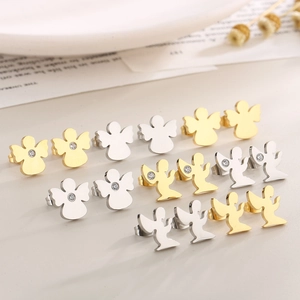 Detailed view of angel stud earrings in gold and silver finish with small rhinestones