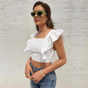 White square neck ruffle sleeve crop top for women paired with denim jeans outdoors