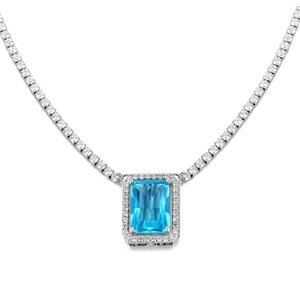 Macro shot of emerald-cut blue gemstone pendant with sparkling white zircon halo necklace