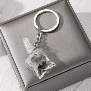 Close-up of tropical fish water bag pendant with silver keychain and resin detail