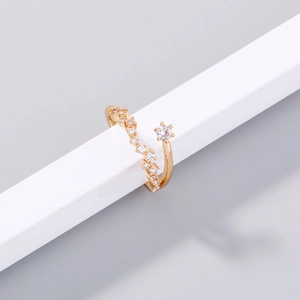 Detail of adjustable gold-plated ring with sparkling wavy zircon and pearl setting