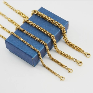 Golden 18K stainless steel dragon bone chains in four sizes on a blue gift box