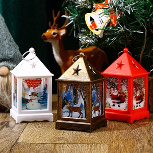 Three decorative Christmas lanterns in white, bronze, and red with festive holiday motifs