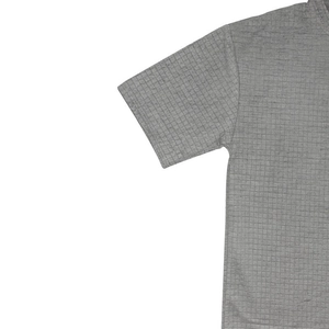 Detailed macro view of the grey waffle knit fabric texture on a men's casual t-shirt