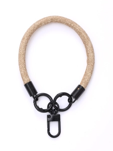 Close-up of woven nylon wrist lanyard with black metal rings and swivel clip connector