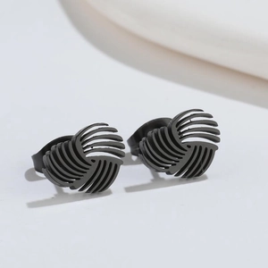 Detailed view of matte black geometric spiral stud earrings with unique swirl texture