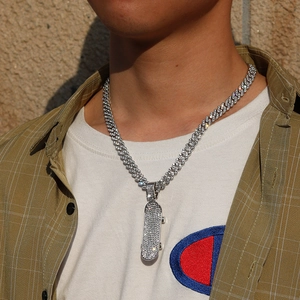 Detail of silver scooter pendant with full rhinestones on Cuban chain for men