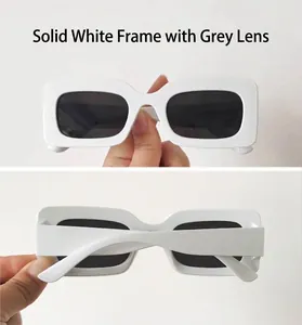 Detail view of rectangular white sunglasses frame with dark grey lenses and Y2K style