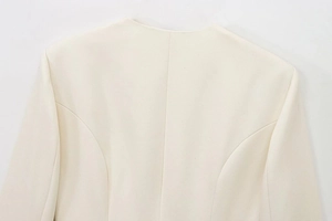 Detail of the back seam and woven texture on this elegant off-white belted blazer