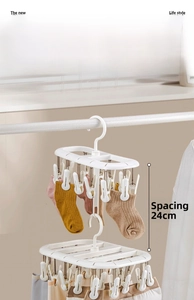 Detailed view of white multi-layer drying rack with 24cm spacing between clips for laundry