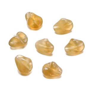Macro shot of irregular amber acrylic beads for DIY jewelry with high gloss finish