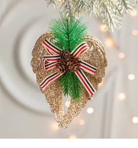 Golden Christmas angel wing ornament with festive bow and pine cones on a tree