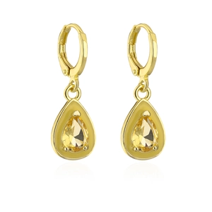 Detailed macro view of gold-plated bohemian drop earrings with yellow zircon gemstones