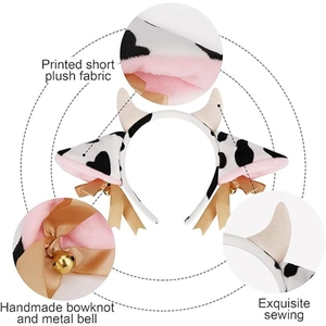 Detail of plush cow ear headband with golden bells, bowknot and soft spotted texture
