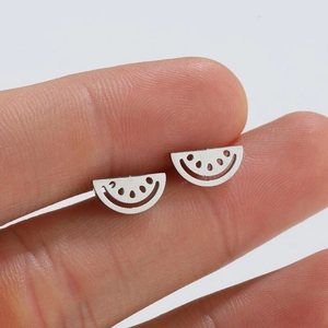 Detailed close-up of hollowed-out silver watermelon stud earrings showing metal texture