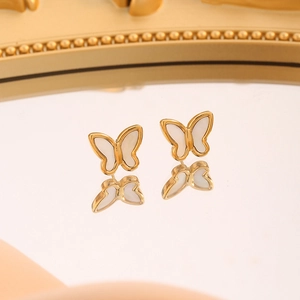 Elegant 18k gold butterfly stud earrings with white shell inlay on reflective mirror
