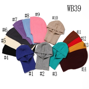 Flat lay of knit balaclava hoods in fourteen colors including blue, grey, and beige