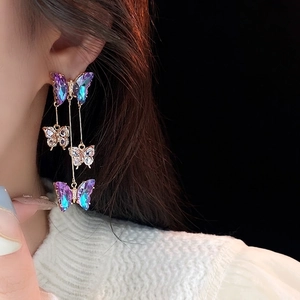 Elegant gold butterfly tassel earrings with purple gradient charms and sparkling crystals