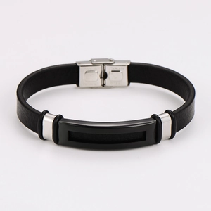 Close-up of a stainless steel buckle and black leather strap with precise stitching