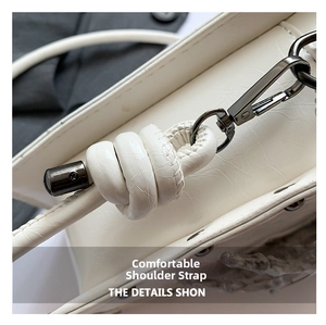 Close-up of cream white PU leather strap with knot detail and gunmetal clasp