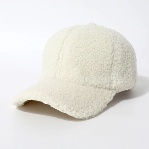 Detail of soft white faux fur lamb wool texture on a warm winter baseball cap