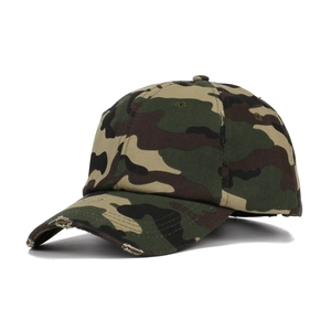Detailed view of woodland camouflage pattern and distressed frayed edges on baseball cap