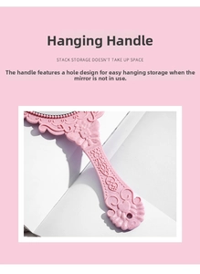 Detail view of the retro embossed handle on a pink handheld mirror with a hanging hole