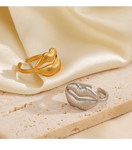 Detail of adjustable lip shaped rings in gold and silver with unique pleated texture