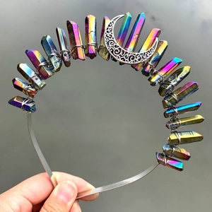 Detail of colorful electroplated crystal crown with crescent moon on silver headband