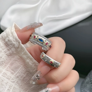 Macro detail of bohemian vintage silver rings with blue and red stones and engravings