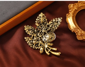 Macro shot of the vintage gold maple leaf brooch back with a secure long pin fastener