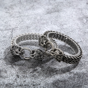 Detail of vintage silver lion head punk bracelets with wheat chain texture and metal rings