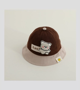 Close-up of baby corduroy sun hat with bear patch and stylish contrast stitching detail