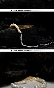 Macro shot of S925 silver irregular beads and freshwater pearls on black wood