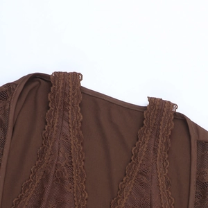 Macro view of dark brown lace stitching and soft fabric texture on wide shoulder strap