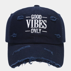 Close-up of Good Vibes Only embroidery and distressed detail on navy baseball cap