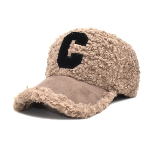 Detail of khaki faux lamb wool baseball cap with black embroidered C and suede brim