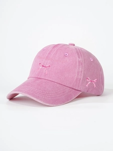 Detailed close-up of pink corduroy baseball cap with bow embroidery and text